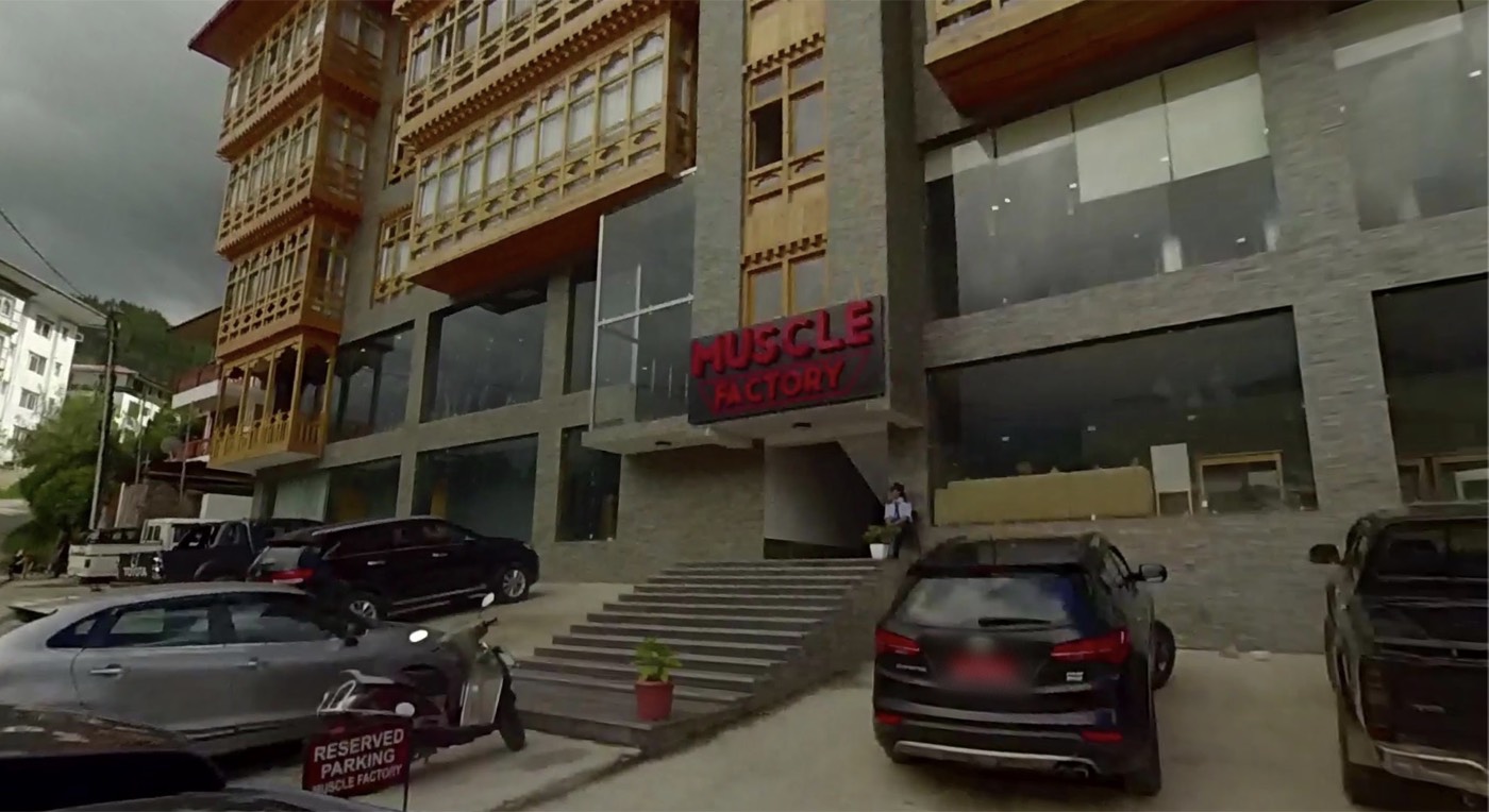 Street view of the building: a wide flight of stone steps leads up to a doorway in the middle of the ground floor, under where a red sign used to hang.